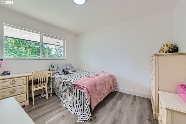 bedroom featuring light wood-type flooring and baseboards