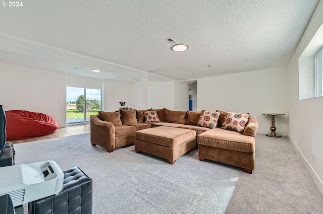 living room with light colored carpet, visible vents, a textured ceiling, and baseboards