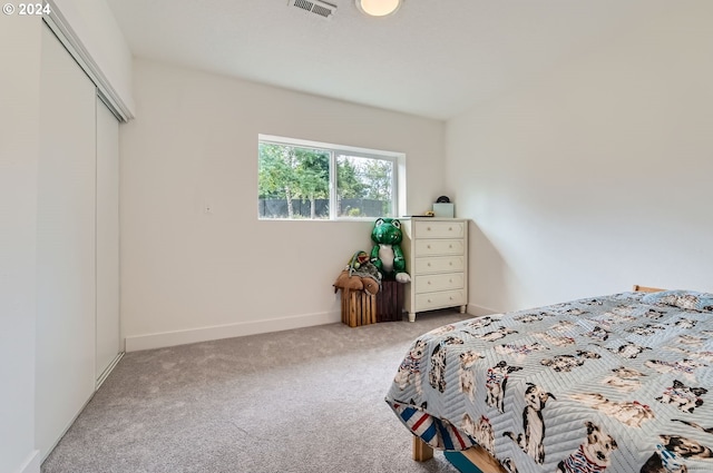 bedroom featuring carpet, a closet, visible vents, and baseboards