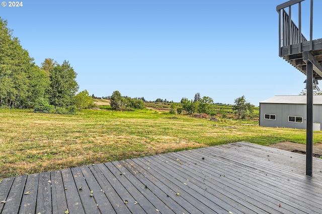 wooden terrace featuring a yard