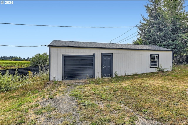 detached garage with driveway and fence