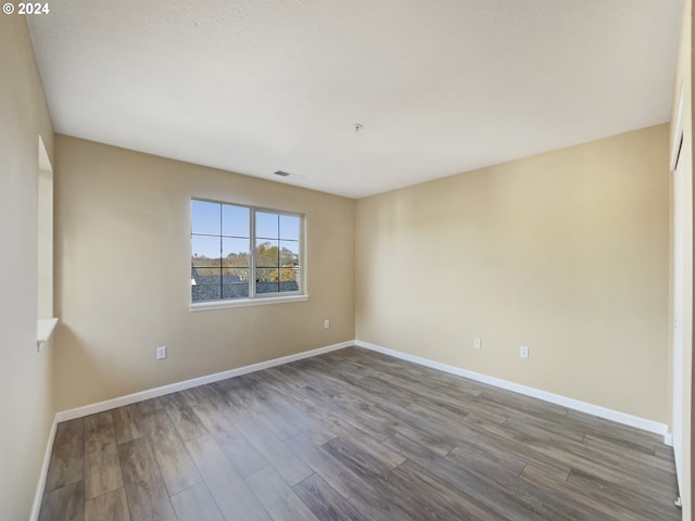 6357 NE Brighton St, Hillsboro, OR 97124 - empty room featuring wood finished floors and baseboards