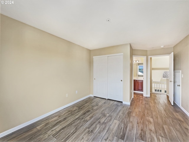 6357 NE Brighton St, Hillsboro, OR 97124 - unfurnished bedroom with wood finished floors, a closet, and baseboards