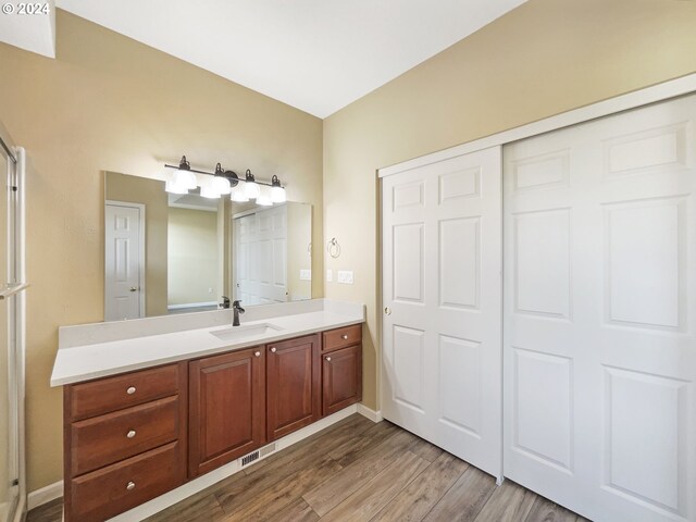 6357 NE Brighton St, Hillsboro, OR 97124 - bathroom with vanity, wood finished floors, and baseboards