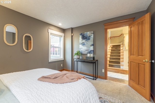 carpeted bedroom featuring a textured ceiling