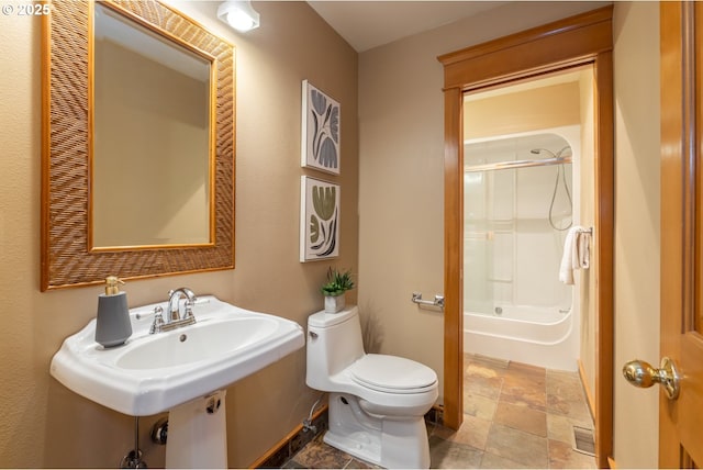 bathroom featuring bathtub / shower combination and toilet