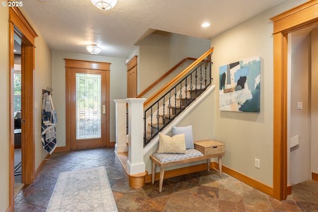 foyer entrance featuring a textured ceiling