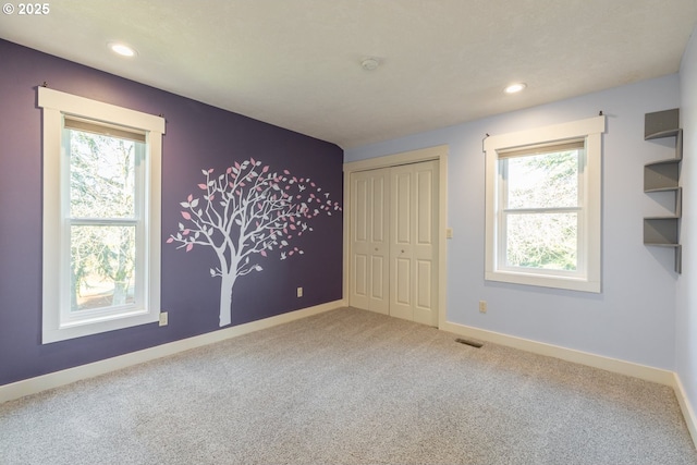 unfurnished bedroom featuring a closet and carpet