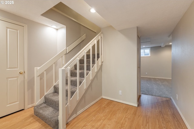 staircase with hardwood / wood-style flooring