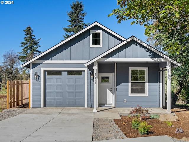 view of front of property with covered porch and a garage