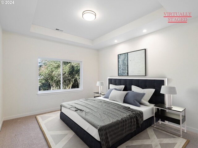 unfurnished living room with light hardwood / wood-style floors, a raised ceiling, and a healthy amount of sunlight