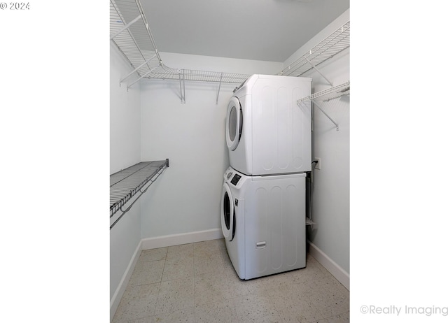 laundry room with stacked washer / dryer