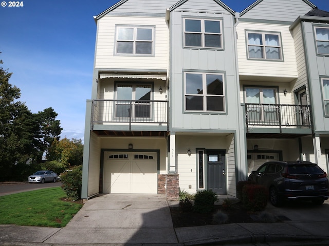 multi unit property featuring a garage and a balcony