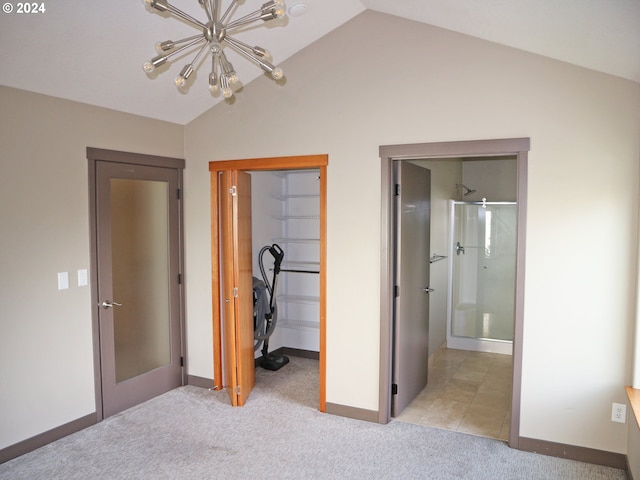 unfurnished bedroom featuring light carpet, lofted ceiling, and a chandelier