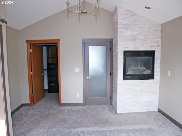 unfurnished bedroom with lofted ceiling, a fireplace, and carpet