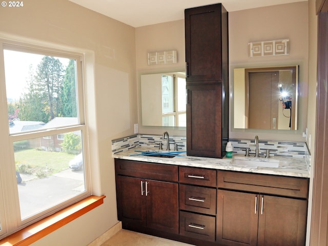 bathroom with vanity and decorative backsplash