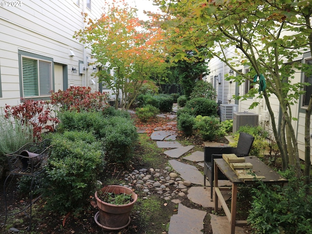 view of yard featuring a patio area and central AC