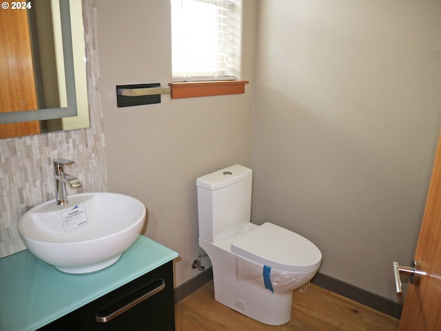 bathroom with vanity, hardwood / wood-style flooring, and toilet