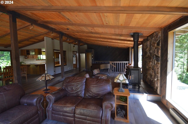 living room with a wood stove, dark hardwood / wood-style flooring, wood ceiling, and vaulted ceiling with beams