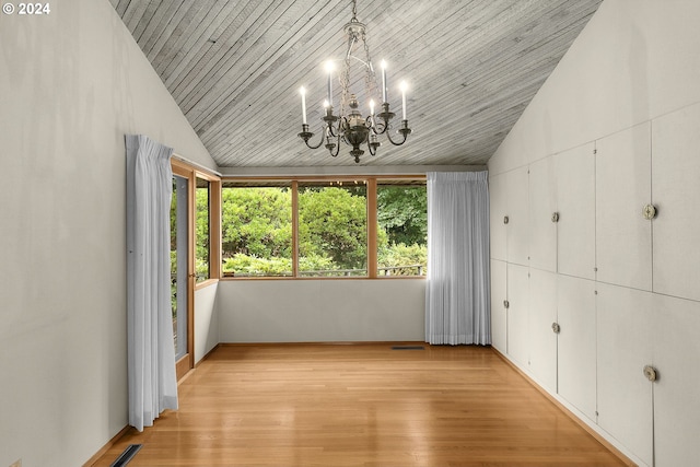 unfurnished bedroom with a notable chandelier, lofted ceiling, visible vents, light wood-style flooring, and wood ceiling