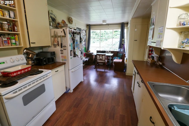 kitchen featuring sink, white cabinets, dark hardwood / wood-style floors, and white appliances