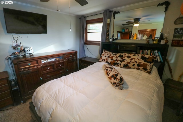 carpeted bedroom featuring ceiling fan and crown molding