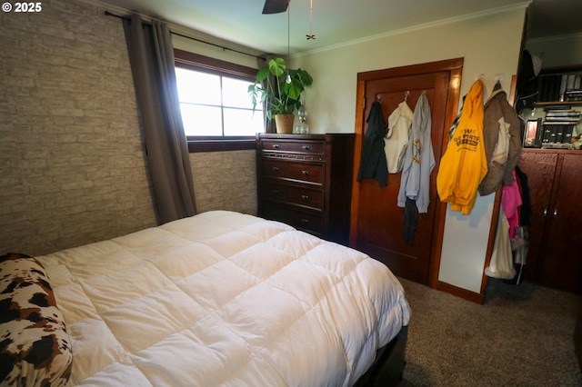 carpeted bedroom featuring ceiling fan and crown molding