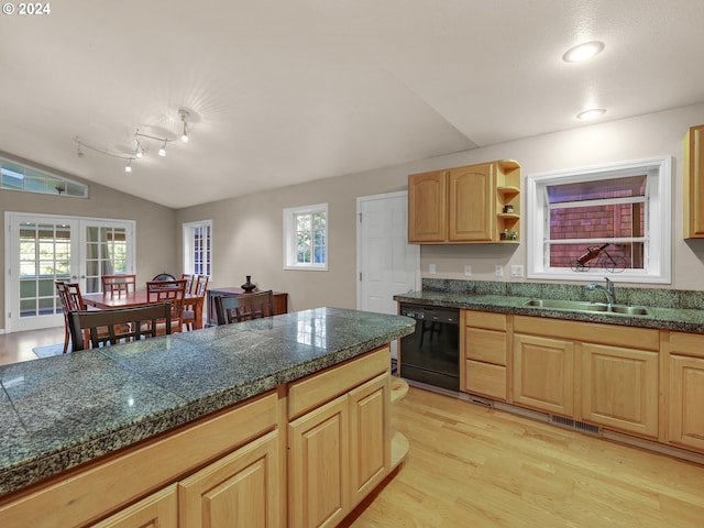 kitchen with light wood-type flooring, dishwasher, sink, vaulted ceiling, and light brown cabinetry