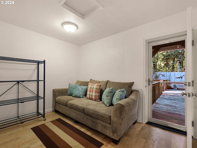 living room featuring hardwood / wood-style flooring and a textured ceiling