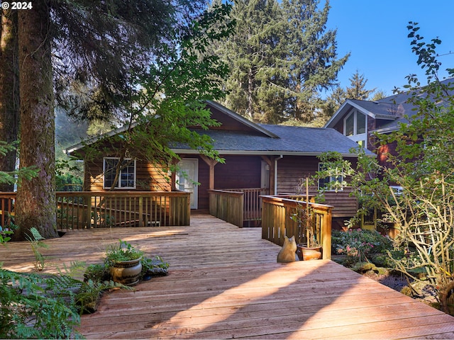 rear view of house with a wooden deck