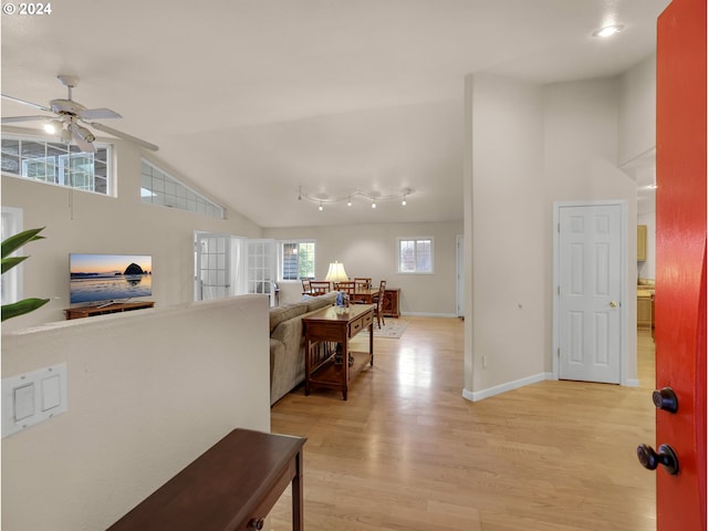 corridor featuring light hardwood / wood-style flooring and vaulted ceiling