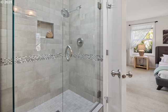 ensuite bathroom with ensuite bath, baseboards, and a shower stall