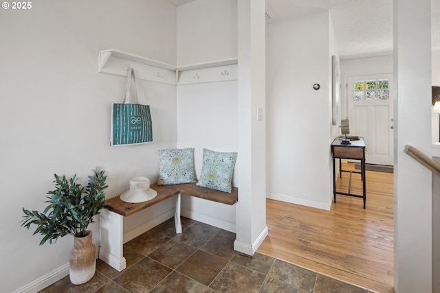 mudroom featuring wood finished floors and baseboards