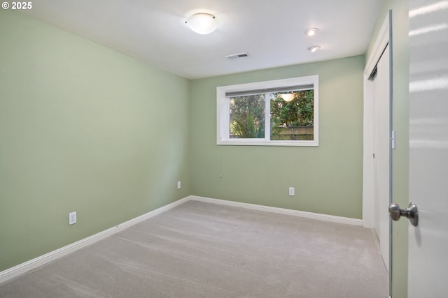 unfurnished bedroom featuring carpet floors, a closet, visible vents, and baseboards