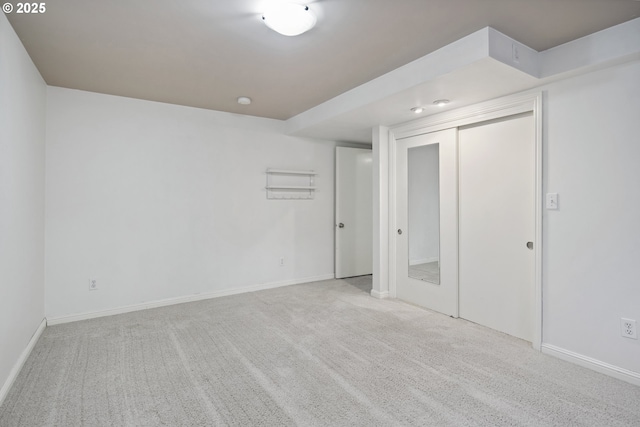 unfurnished bedroom with carpet floors, a closet, and baseboards