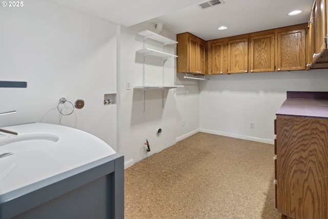 clothes washing area featuring gas dryer hookup, recessed lighting, visible vents, baseboards, and cabinet space