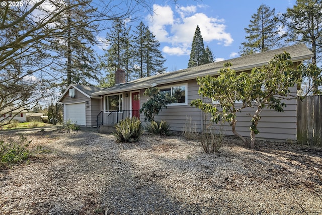 single story home with a chimney and an attached garage