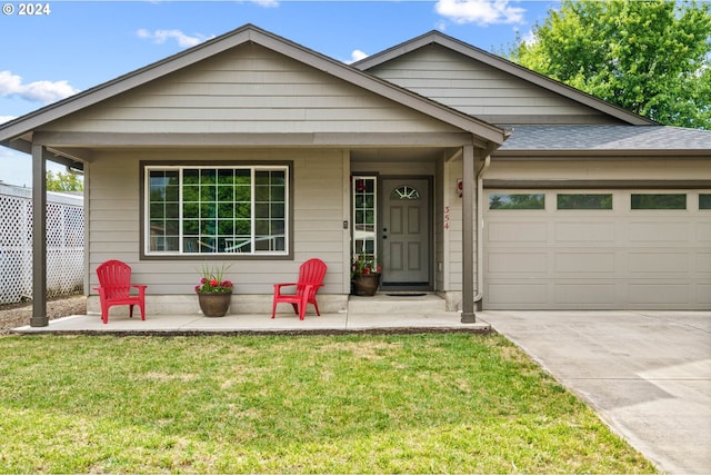 view of front of home featuring a garage and a front lawn