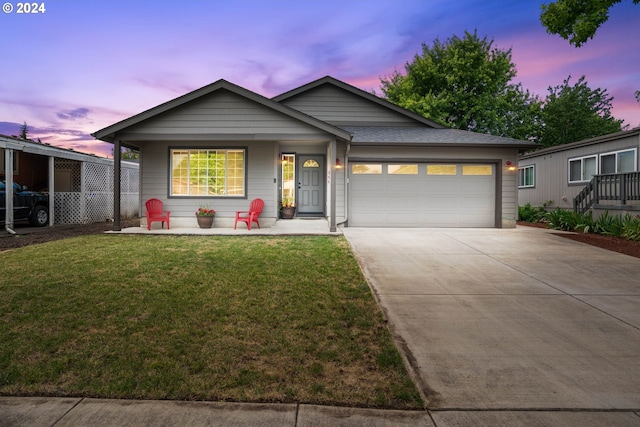 view of front facade with a yard, a garage, and a carport