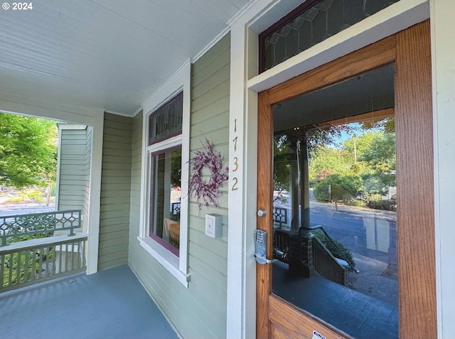 doorway to property featuring covered porch
