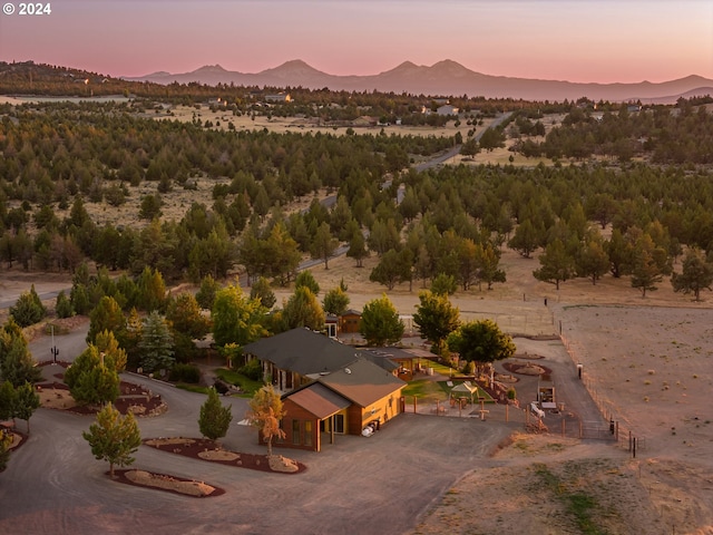 aerial view at dusk featuring a mountain view