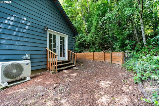 view of yard with french doors and ac unit