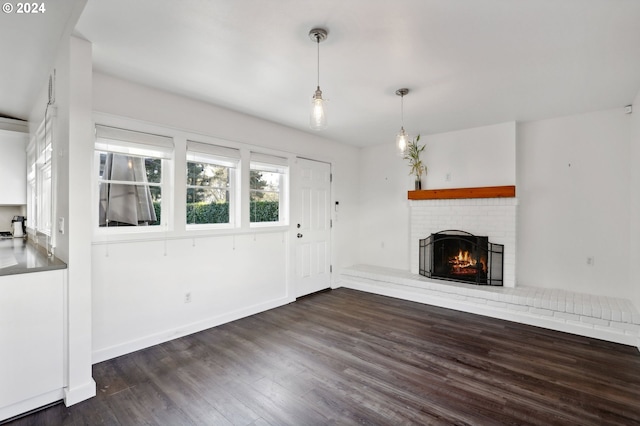 unfurnished living room with a fireplace and dark hardwood / wood-style flooring