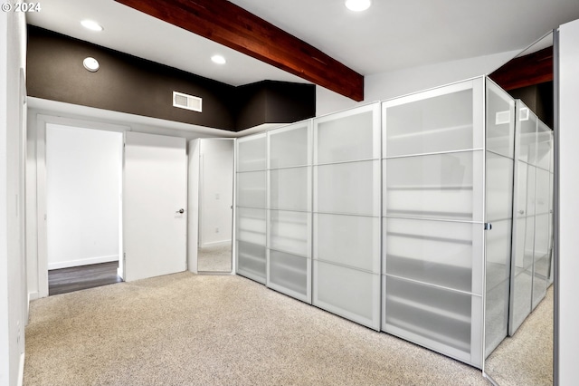 interior space featuring beam ceiling and carpet floors