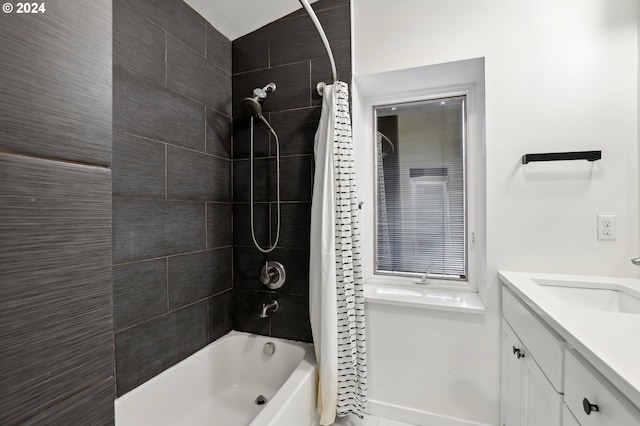 bathroom with shower / bath combo and vanity