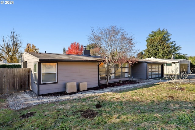 rear view of house featuring a yard