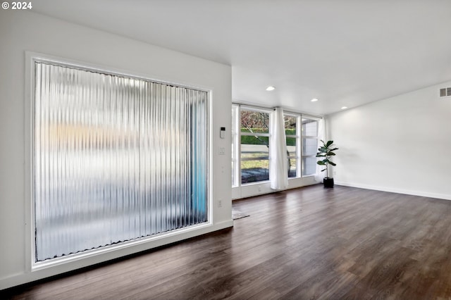 unfurnished living room with dark hardwood / wood-style flooring