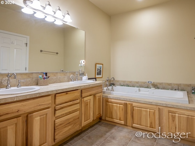 bathroom featuring tile patterned floors, a washtub, and vanity