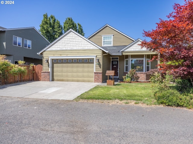 craftsman inspired home with a garage and a front yard