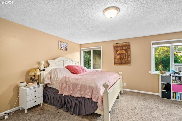 carpeted bedroom featuring a textured ceiling